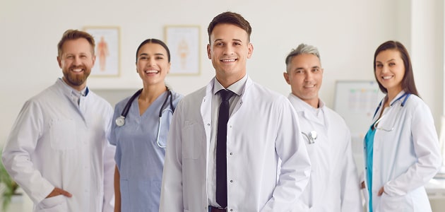 Group of physicians in lab coats and scrubs, illustrating Polymath Investments’ specialized financial services for doctors and healthcare professionals.