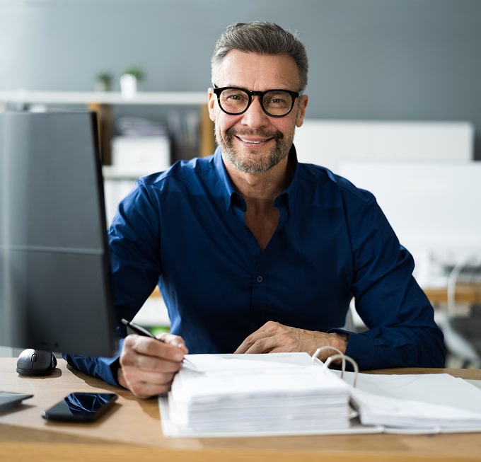 Confident financial advisor working at a desk, representing expertise and client-focused service.